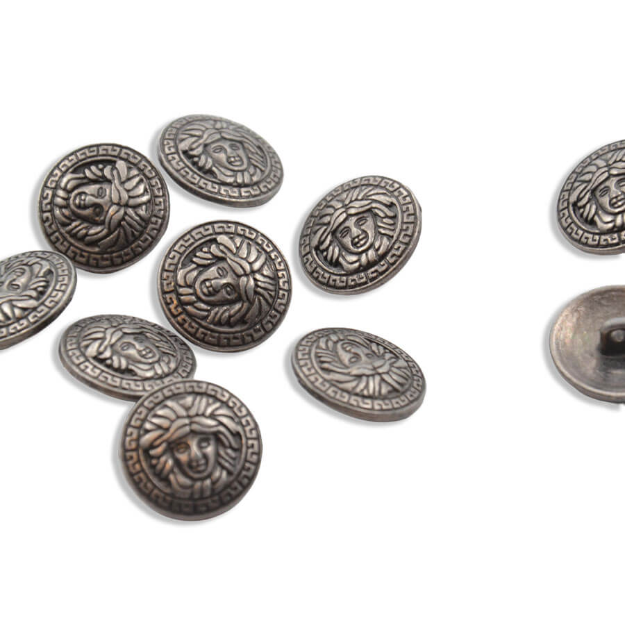 Botón metálico con cabeza de Medusa en acabado oro